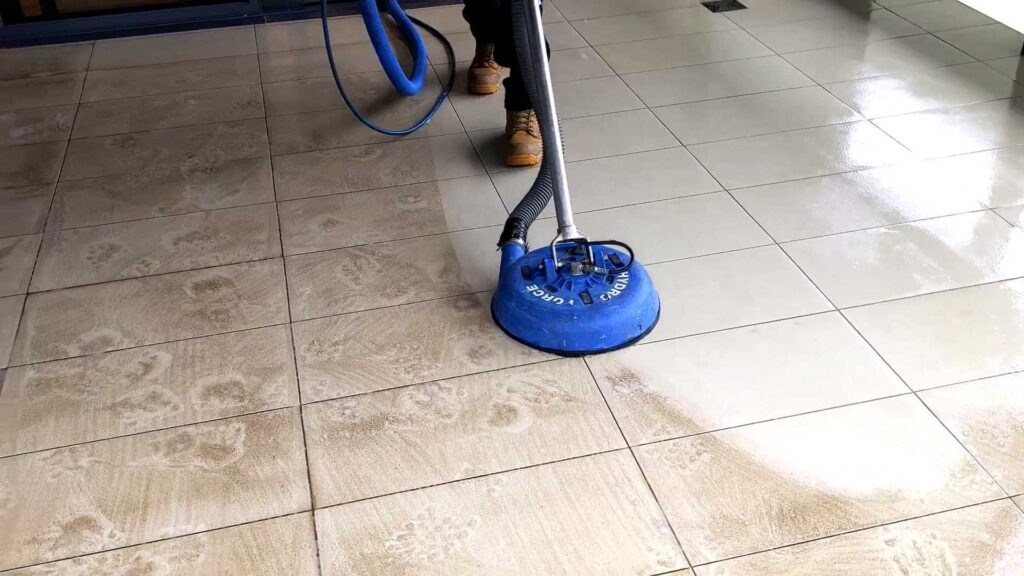 guy cleaning the floor tiles in the living room